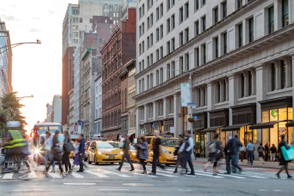 Fast-paced-street-scene-with-people-walking-across-a-busy-intersection-on-Broadway-in-Manhattan-New-York-City-985069722_2124x1416-1-1024x683-1024x683
